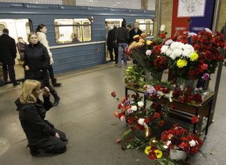 A woman mourning at a memorial to the victims of a suicide bombing on the Moscow subway in 2010 